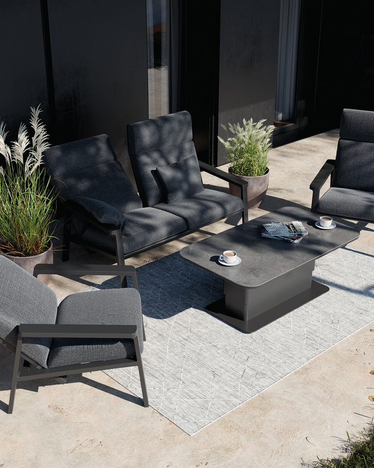 Outdoor patio set from Royal Garden with gray cushioned chairs and table on a patio area.